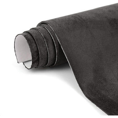 Adhesive suede interior wrap applied to door panels and armrests for a refined and comfortable touch